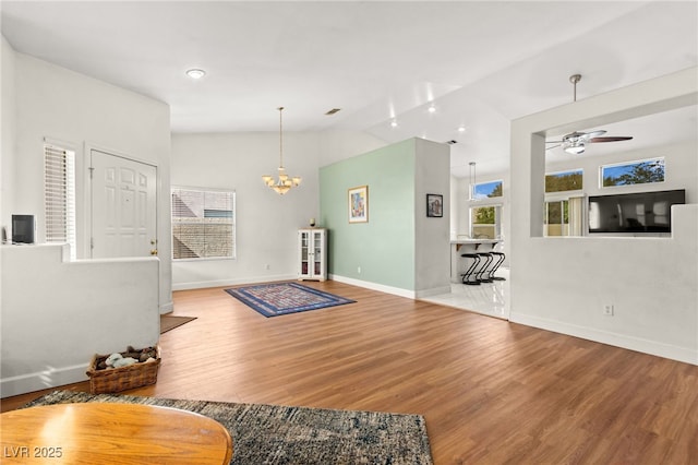 5224 Dana Springs Way, Las Vegas, NV 89130 - living area with vaulted ceiling, baseboards, wood finished floors, and ceiling fan with notable chandelier