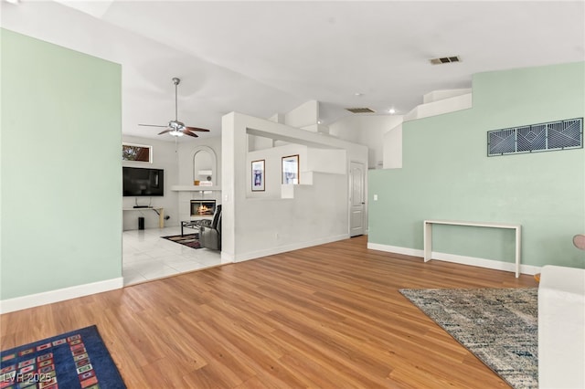 5224 Dana Springs Way, Las Vegas, NV 89130 - unfurnished living room featuring lofted ceiling, wood finished floors, visible vents, and a ceiling fan