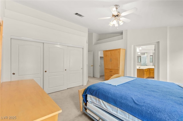 5224 Dana Springs Way, Las Vegas, NV 89130 - bedroom featuring light carpet, ensuite bathroom, visible vents, a ceiling fan, and a closet