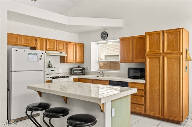 5224 Dana Springs Way, Las Vegas, NV 89130 - kitchen featuring a center island, black appliances, tile counters, under cabinet range hood, and light tile patterned floors