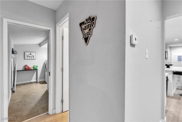 5208 Overland Ave, Las Vegas, NV 89107 - hallway featuring washer and clothes dryer and light wood-style floors