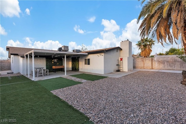 5208 Overland Ave, Las Vegas, NV 89107 - back of house featuring stucco siding, a patio, and central air condition unit