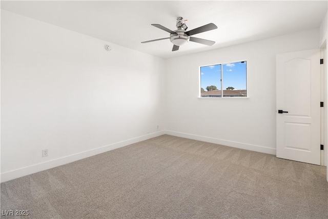 empty room with light carpet, a ceiling fan, and baseboards