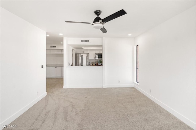 unfurnished living room with light colored carpet, ceiling fan, baseboards, and visible vents