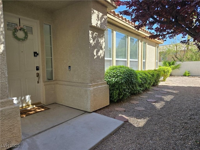 9324 Pitching Wedge Dr, Las Vegas, NV 89134 - doorway to property featuring stucco siding, fence, and a tiled roof