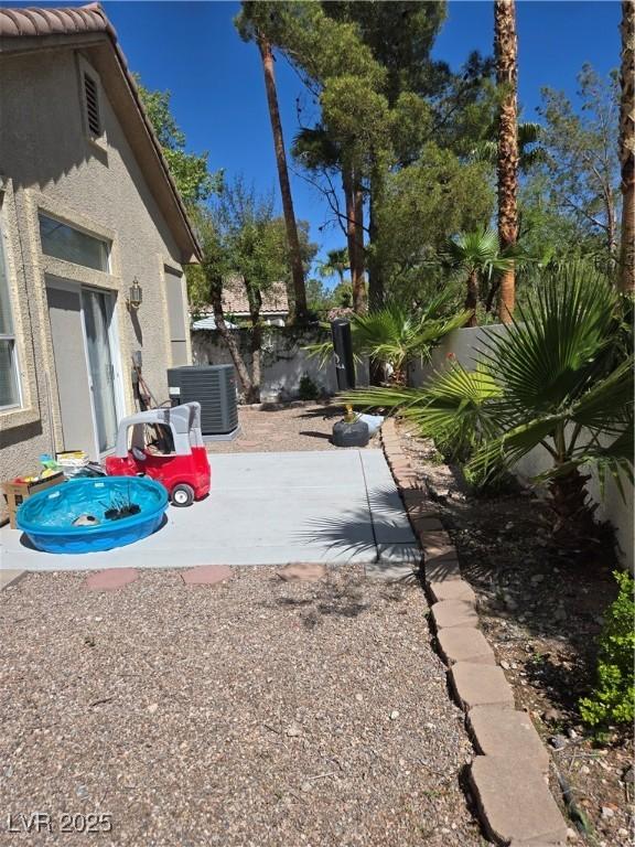 9324 Pitching Wedge Dr, Las Vegas, NV 89134 - view of yard with cooling unit, a patio area, and fence