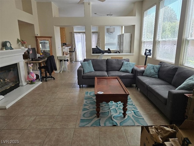 9324 Pitching Wedge Dr, Las Vegas, NV 89134 - living area featuring tile patterned floors, a glass covered fireplace, and ceiling fan
