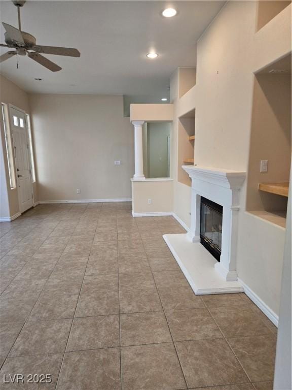9324 Pitching Wedge Dr, Las Vegas, NV 89134 - unfurnished living room featuring a glass covered fireplace, a ceiling fan, built in features, tile patterned flooring, and recessed lighting