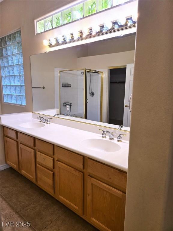 9324 Pitching Wedge Dr, Las Vegas, NV 89134 - full bathroom featuring a stall shower, tile patterned floors, double vanity, and a walk in closet