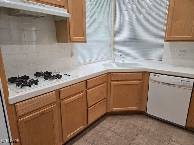 9324 Pitching Wedge Dr, Las Vegas, NV 89134 - kitchen with white appliances, under cabinet range hood, a sink, and tasteful backsplash