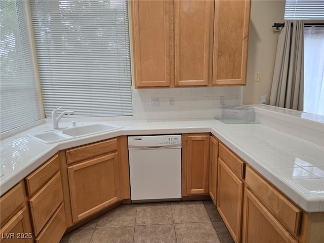9324 Pitching Wedge Dr, Las Vegas, NV 89134 - kitchen with white dishwasher, a sink, tile countertops, and light tile patterned flooring