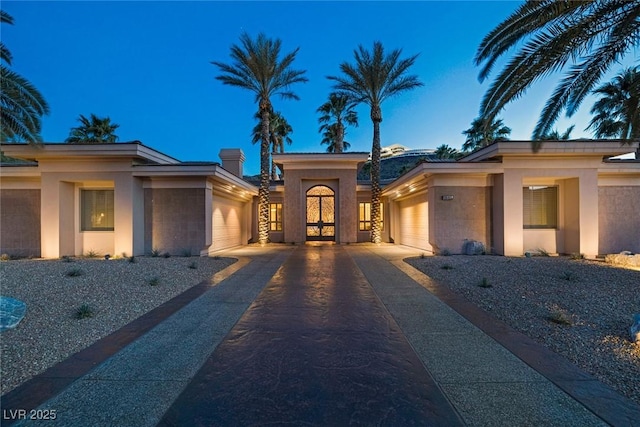 1665 Liege Dr, Henderson, NV 89012 - view of front of home with stucco siding, an attached garage, and driveway