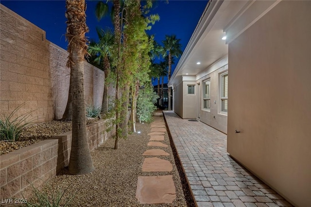 1665 Liege Dr, Henderson, NV 89012 - property exterior at twilight featuring stucco siding, fence, and a patio area