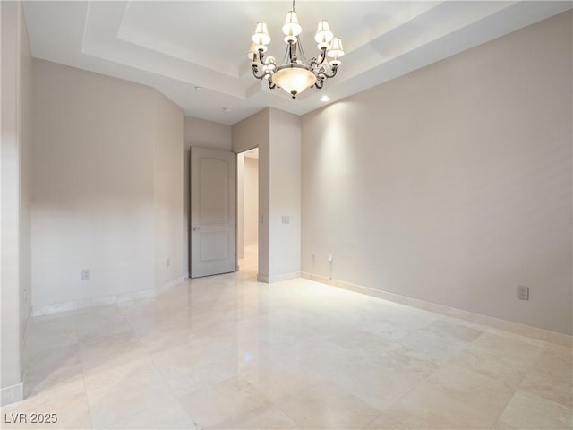 1665 Liege Dr, Henderson, NV 89012 - spare room featuring baseboards, a notable chandelier, and a tray ceiling