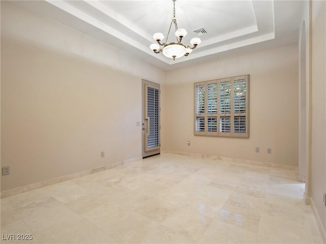 1665 Liege Dr, Henderson, NV 89012 - spare room featuring an inviting chandelier, a tray ceiling, visible vents, and baseboards