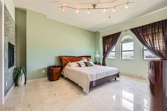 2455 W Serene Ave Unit 923, Las Vegas, NV 89123 - bedroom featuring light marble finish flooring, baseboards, and a fireplace