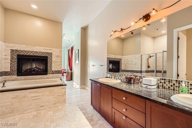 2455 W Serene Ave Unit 923, Las Vegas, NV 89123 - bathroom featuring a fireplace, backsplash, and a stall shower