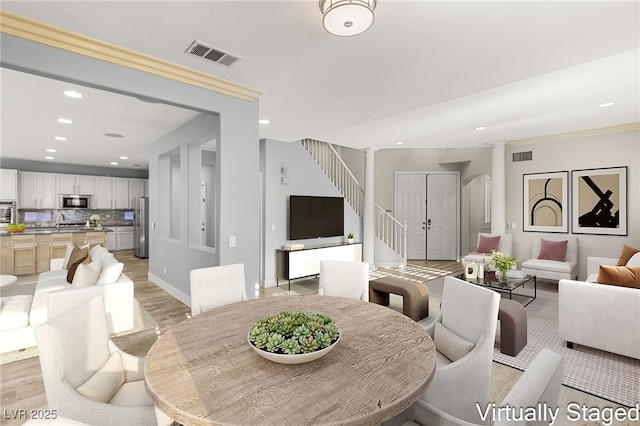 11784 Golden Moments Ave, Las Vegas, NV 89138 - dining room featuring recessed lighting, visible vents, decorative columns, light wood-style flooring, and stairs