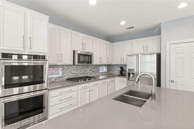 11784 Golden Moments Ave, Las Vegas, NV 89138 - kitchen featuring visible vents, appliances with stainless steel finishes, white cabinetry, and a sink