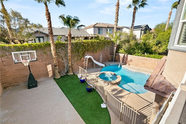 11784 Golden Moments Ave, Las Vegas, NV 89138 - view of pool with a water slide, a pool with connected hot tub, and a fenced backyard