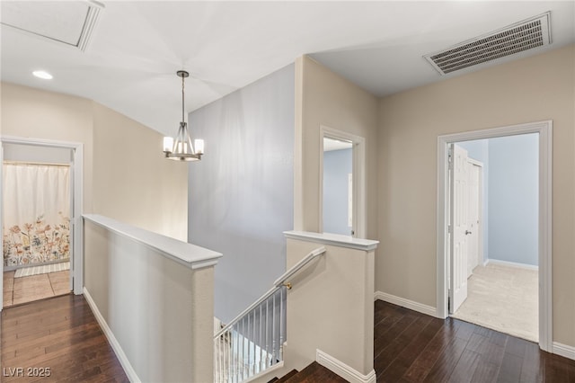11784 Golden Moments Ave, Las Vegas, NV 89138 - hall featuring dark wood-type flooring, visible vents, baseboards, and an upstairs landing