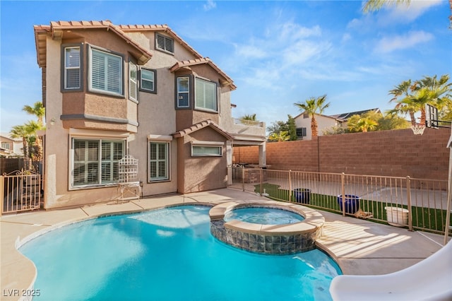 11784 Golden Moments Ave, Las Vegas, NV 89138 - back of house with fence, a patio area, a pool with connected hot tub, and stucco siding