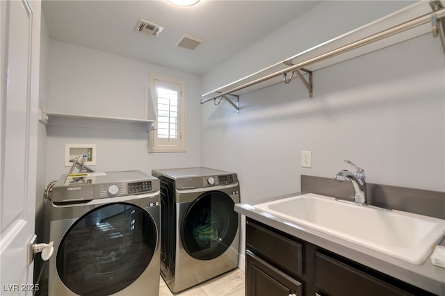 11784 Golden Moments Ave, Las Vegas, NV 89138 - laundry room featuring cabinet space, a sink, visible vents, and independent washer and dryer
