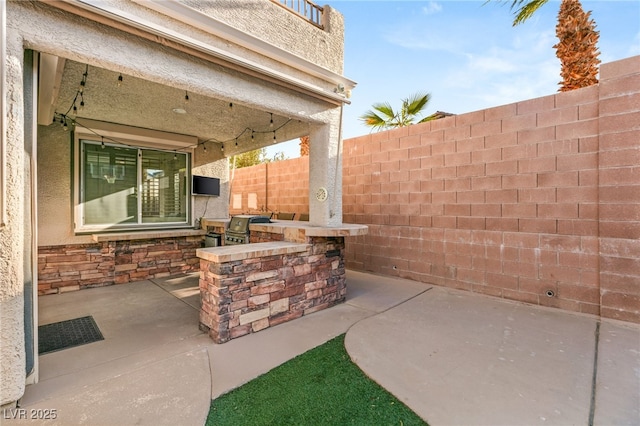 11784 Golden Moments Ave, Las Vegas, NV 89138 - view of patio / terrace featuring fence, grilling area, and exterior kitchen
