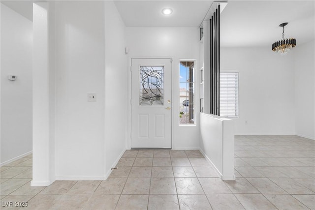 foyer entrance featuring a chandelier, baseboards, recessed lighting, and light tile patterned floors