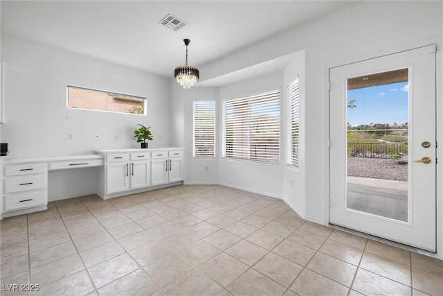 unfurnished dining area featuring a chandelier, visible vents, and light tile patterned floors