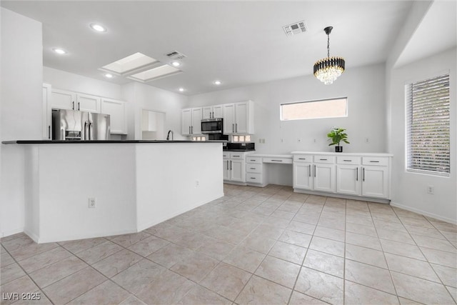 kitchen featuring white cabinetry, appliances with stainless steel finishes, dark countertops, and visible vents