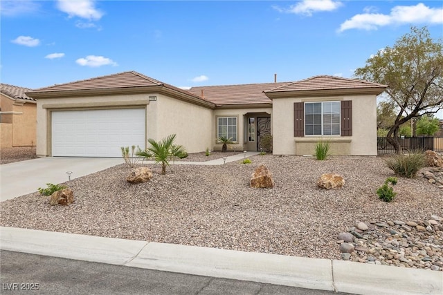 ranch-style house featuring fence, concrete driveway, an attached garage, a tile roof, and stucco siding
