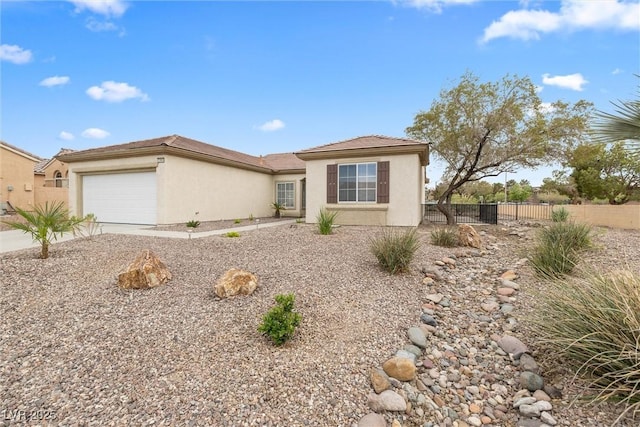 view of front of property featuring stucco siding, an attached garage, fence, and driveway