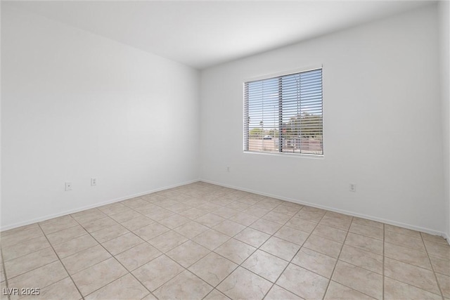 unfurnished room with baseboards and light tile patterned floors