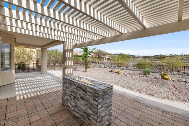 view of patio with fence and an outdoor fire pit