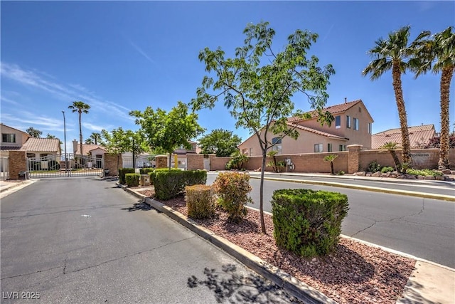 8942 Galena Crossing St, Las Vegas, NV 89123 - view of asphalt road featuring a residential view, a gate, curbs, a gated entry, and sidewalks