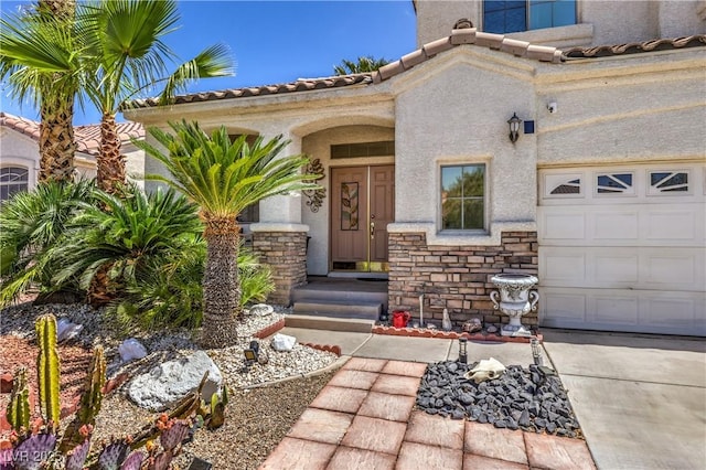 8942 Galena Crossing St, Las Vegas, NV 89123 - entrance to property featuring stone siding, stucco siding, a tiled roof, and an attached garage