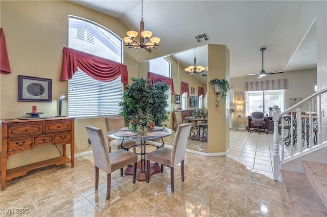 8942 Galena Crossing St, Las Vegas, NV 89123 - tiled dining room with a chandelier, stairs, baseboards, a ceiling fan, and high vaulted ceiling