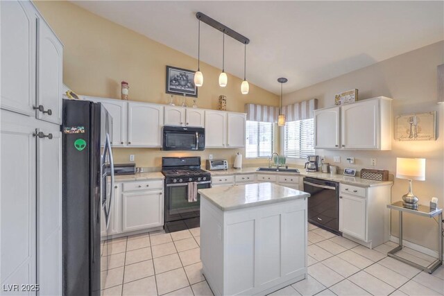 8942 Galena Crossing St, Las Vegas, NV 89123 - kitchen with black appliances, a sink, vaulted ceiling, white cabinets, and light tile patterned floors