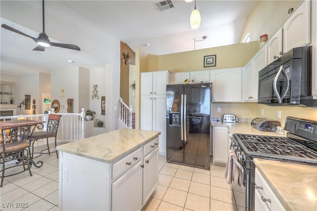 8942 Galena Crossing St, Las Vegas, NV 89123 - kitchen featuring black appliances, light tile patterned floors, a ceiling fan, white cabinetry, and lofted ceiling