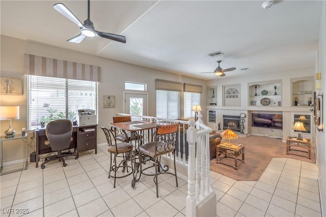 8942 Galena Crossing St, Las Vegas, NV 89123 - dining space featuring ceiling fan, light tile patterned floors, an office area, a tile fireplace, and baseboards