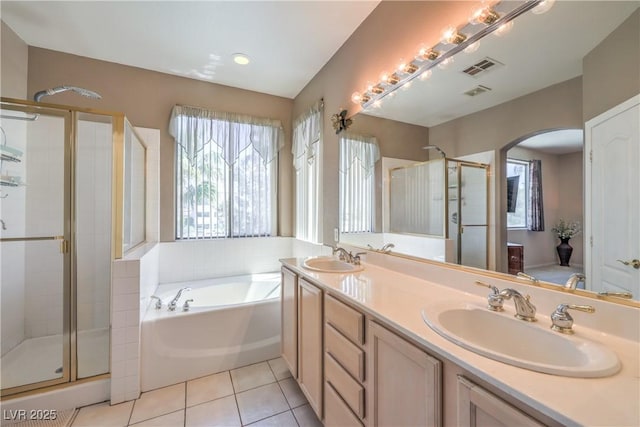 8942 Galena Crossing St, Las Vegas, NV 89123 - bathroom featuring a shower stall, a bath, tile patterned flooring, and double vanity