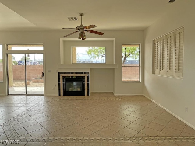 825 Happy Sparrow Ave, Henderson, NV 89052 - unfurnished living room with a fireplace, visible vents, a ceiling fan, and baseboards