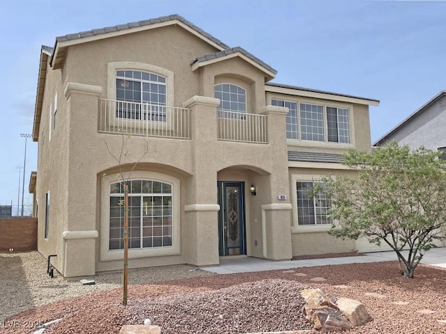 825 Happy Sparrow Ave, Henderson, NV 89052 - view of front of home featuring stucco siding, fence, and a balcony