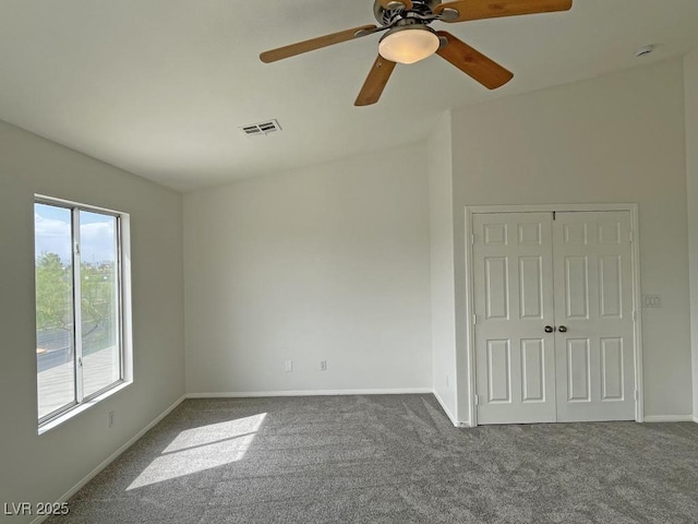 825 Happy Sparrow Ave, Henderson, NV 89052 - unfurnished room featuring baseboards, dark colored carpet, visible vents, and ceiling fan
