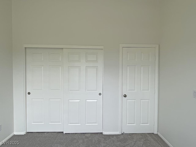 825 Happy Sparrow Ave, Henderson, NV 89052 - unfurnished bedroom with baseboards, dark carpet, and a closet