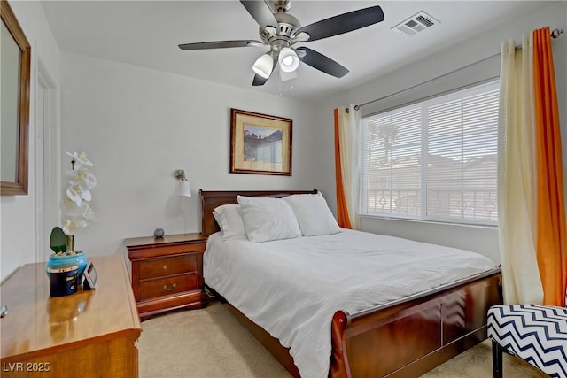 carpeted bedroom with ceiling fan and visible vents