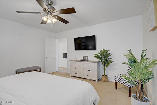 bedroom with light colored carpet and a ceiling fan