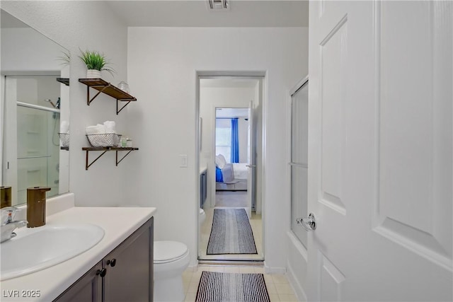 bathroom with vanity, tile patterned flooring, visible vents, toilet, and a shower with shower door