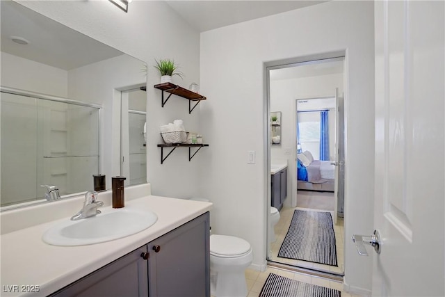 bathroom featuring vanity, tile patterned floors, ensuite bathroom, and toilet